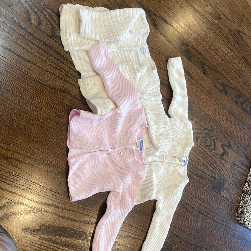 3  different 12 month button sweaters. 2 pure white and 1 pink.